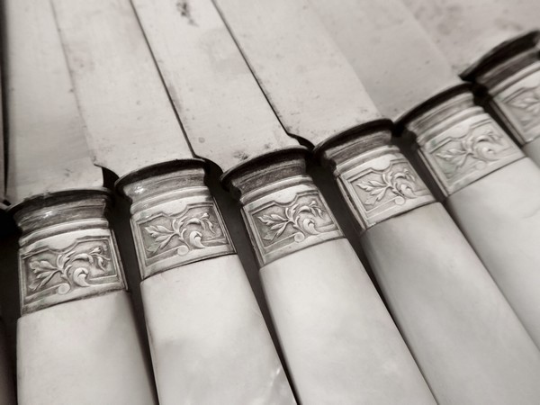 12 table knives, Louis XV style, mother of pearl handle, silver ferrules dans caps