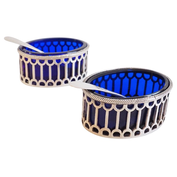 Pair of Louis XVI style sterling silver salt cellars and their blue glass