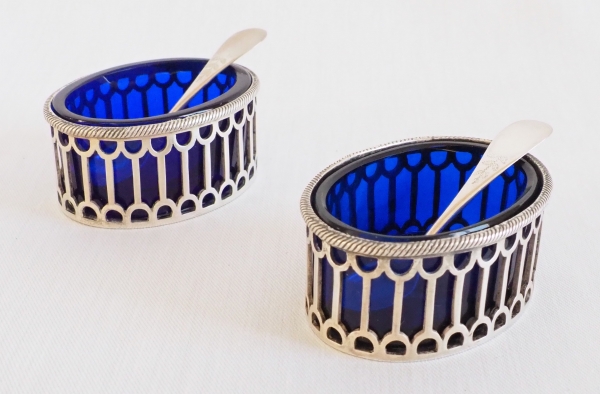 Pair of Louis XVI style sterling silver salt cellars and their blue glass