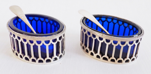 Pair of Louis XVI style sterling silver salt cellars and their blue glass