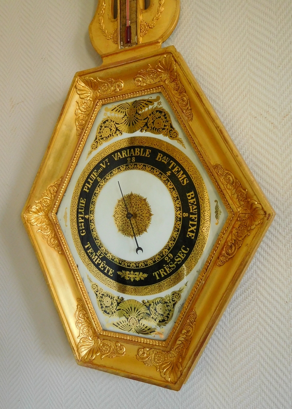 Empire barometer set into a carved and gilt wood frame - early 19th century