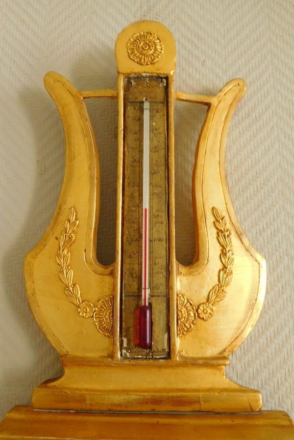 Empire barometer set into a carved and gilt wood frame - early 19th century