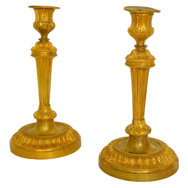 Pair of Louis XVI style ormolu candlesticks after a design by Feuchere, late 19th century