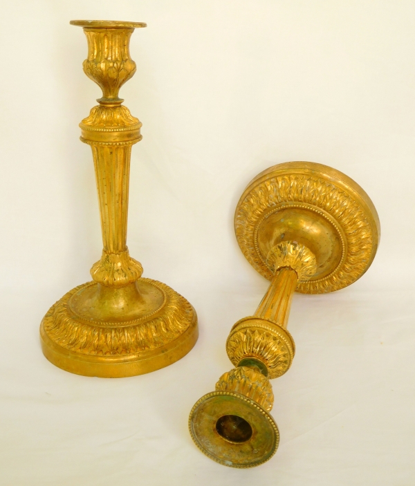 Pair of Louis XVI style ormolu candlesticks after a design by Feuchere, late 19th century
