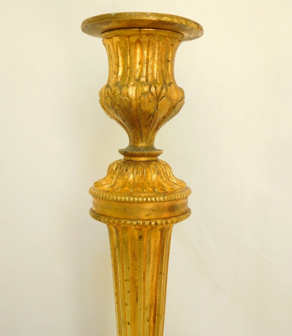 Pair of Louis XVI style ormolu candlesticks after a design by Feuchere, late 19th century
