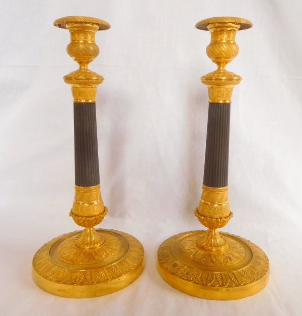 Pair of patinated bronze and ormolu candlesticks, early 19th century