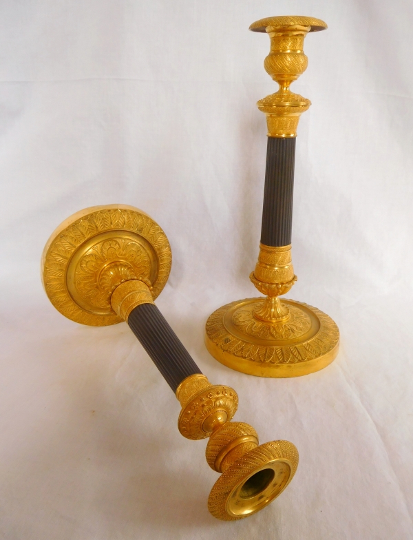 Pair of patinated bronze and ormolu candlesticks, early 19th century