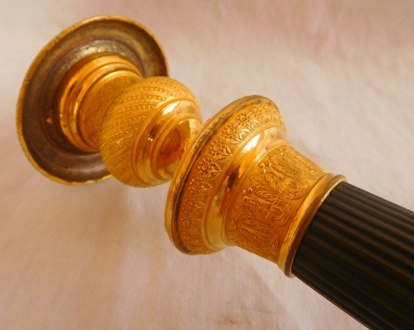 Pair of patinated bronze and ormolu candlesticks, early 19th century