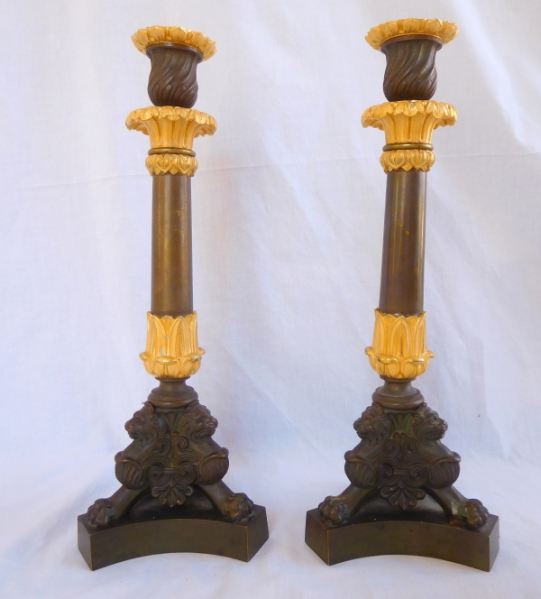 Pair of patinated bronze and ormolu tripod candlesticks, early 19th century