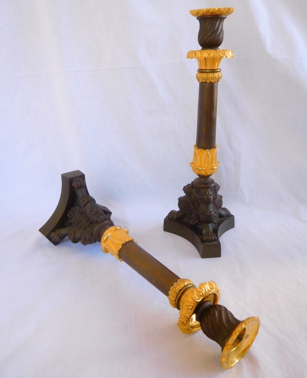 Pair of patinated bronze and ormolu tripod candlesticks, early 19th century