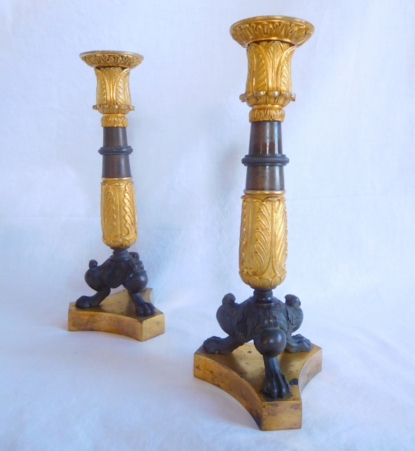 Pair of patinated bronze and ormolu tripod candlesticks, early 19th century