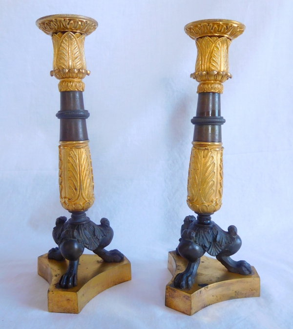 Pair of patinated bronze and ormolu tripod candlesticks, early 19th century