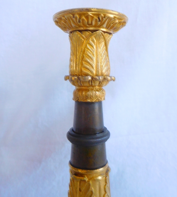 Pair of patinated bronze and ormolu tripod candlesticks, early 19th century