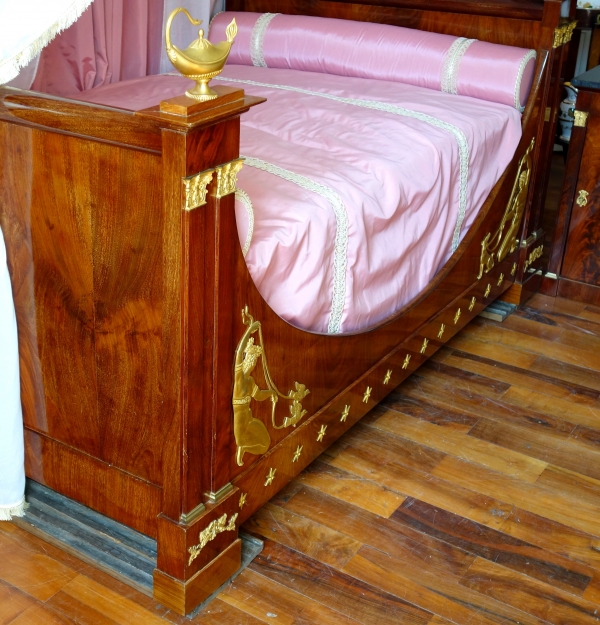 Empire mahogany and ormolu canopy bed and its matching bedside table, early 19th century