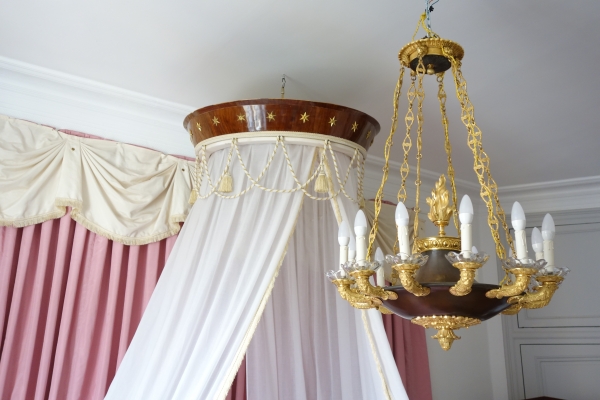 Empire mahogany and ormolu canopy bed and its matching bedside table, early 19th century