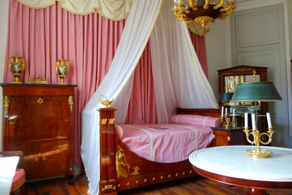 Empire mahogany and ormolu canopy bed and its matching bedside table, early 19th century