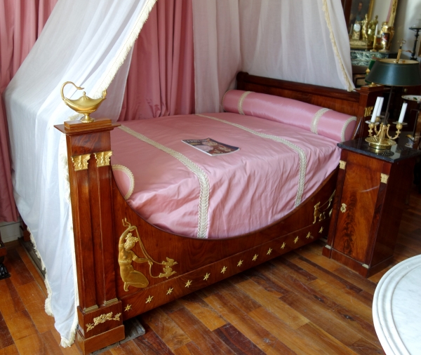 Empire mahogany and ormolu canopy bed and its matching bedside table, early 19th century