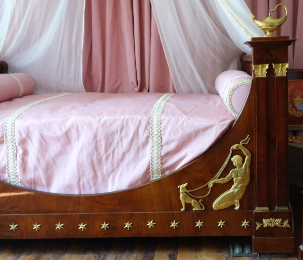 Empire mahogany and ormolu canopy bed and its matching bedside table, early 19th century