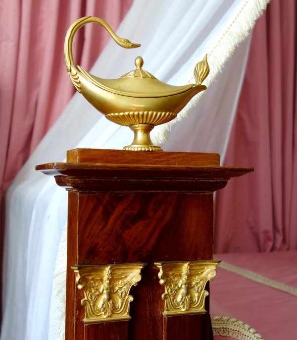 Empire mahogany and ormolu canopy bed and its matching bedside table, early 19th century