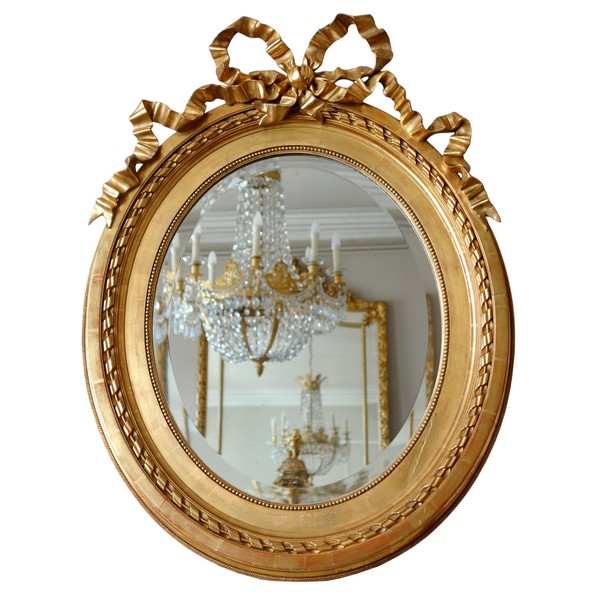 Large oval Louis XVI style mirror, gold leaf gilt wood frame, Napoleon III period - 84cm x 63cm