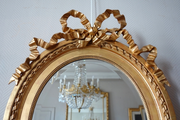 Large oval Louis XVI style mirror, gold leaf gilt wood frame, Napoleon III period - 84cm x 63cm