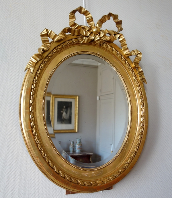 Large oval Louis XVI style mirror, gold leaf gilt wood frame, Napoleon III period - 84cm x 63cm