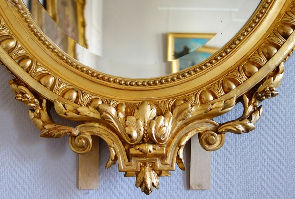 Louis XVI style gilt wood oval mirror decorated with putti, 19th century