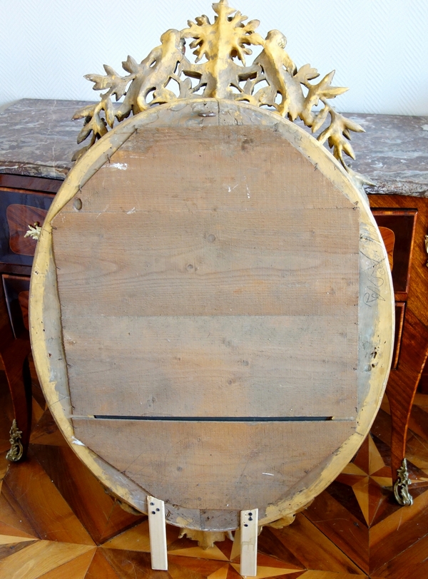 Louis XVI style gilt wood oval mirror decorated with putti, 19th century