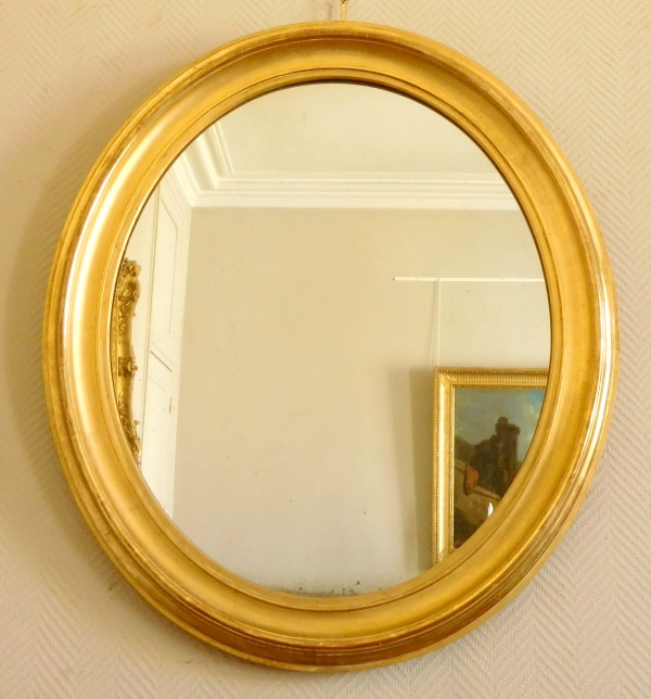 Miroir ovale en bois doré à la feuille d'or, glace au mercure, d'époque XIXe - 80cm x 67cm