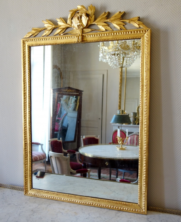 Tall Louis XVI mirror, music trophy patterned frame gilt with gold leaf - late 18th century