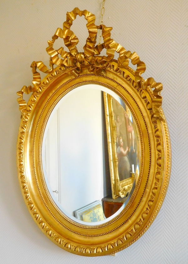 Tall Louis XVI style gilt wood oval mirror, Napoleon III period - 77cm x 104cm