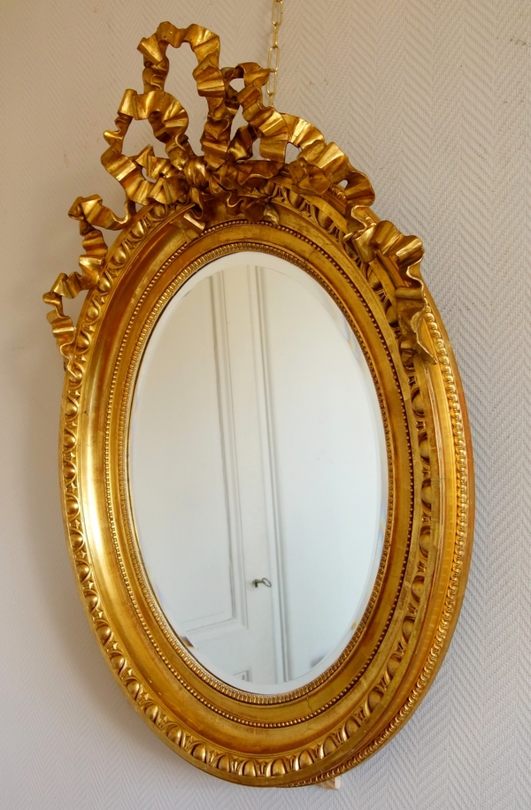 Tall Louis XVI style gilt wood oval mirror, Napoleon III period - 77cm x 104cm