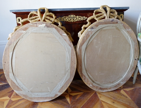 Pair of Louis XVI style gold leaf gilt wood oval mirrors, 19th century