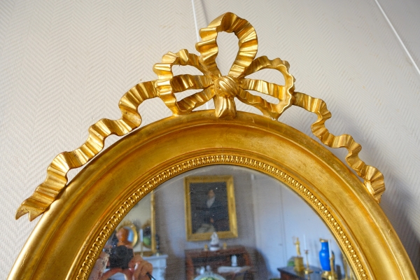 Pair of Louis XVI style gold leaf gilt wood oval mirrors, 19th century