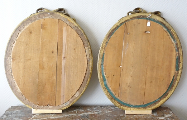 Pair of Louis XVI style gold leaf gilt wood oval mirrors, 19th century