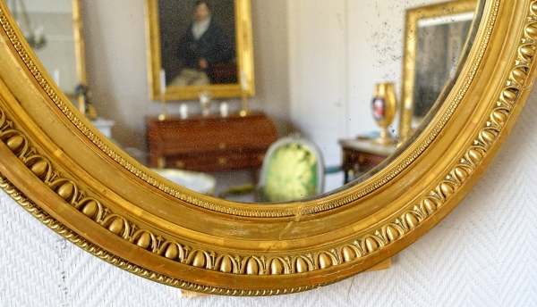 Pair of Louis XVI style gold leaf gilt wood oval mirrors, 19th century