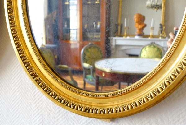 Pair of Louis XVI style gold leaf gilt wood oval mirrors, 19th century