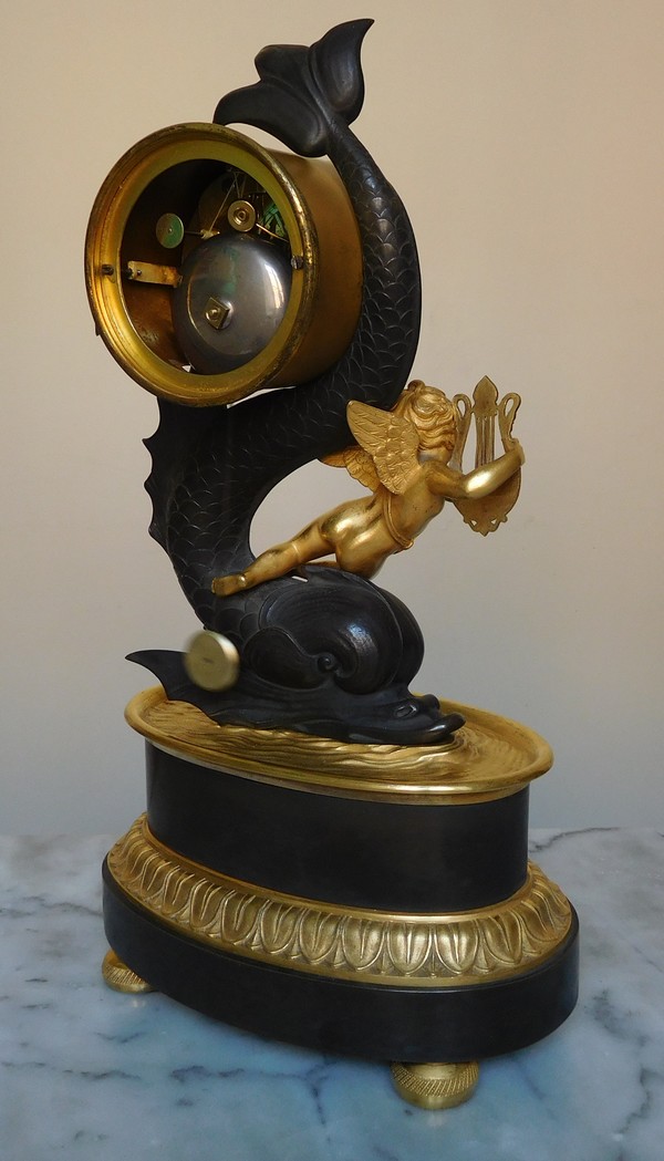 Empire clock, ormolu and patinated bronze, dolphin and putti, 19th century (circa 1820)