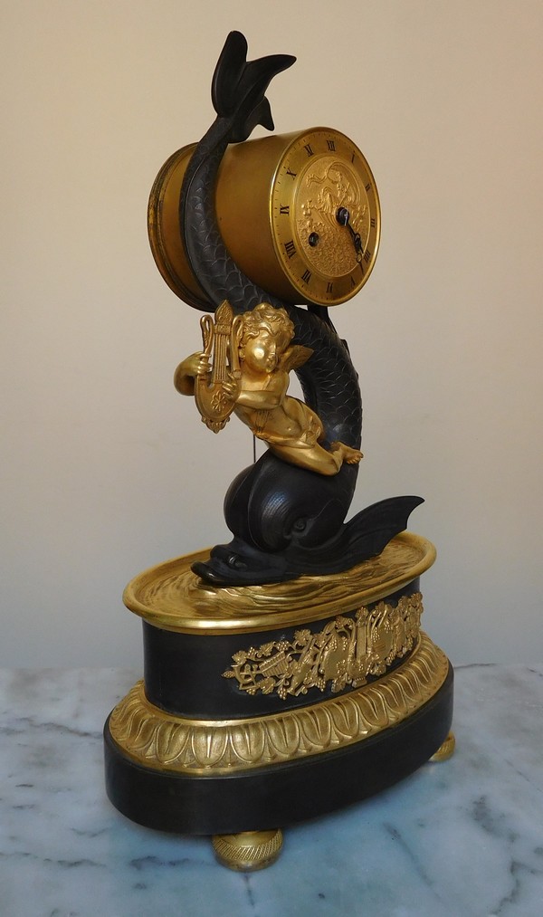 Empire clock, ormolu and patinated bronze, dolphin and putti, 19th century (circa 1820)