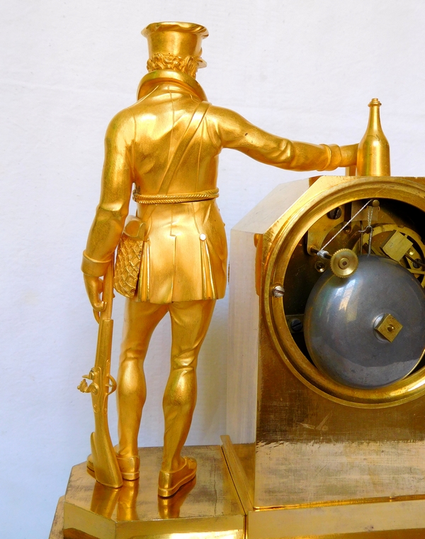 Empire ormolu clock picturing a hunter, early 19th century