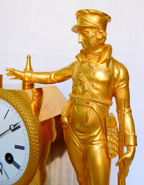 Empire ormolu clock picturing a hunter, early 19th century