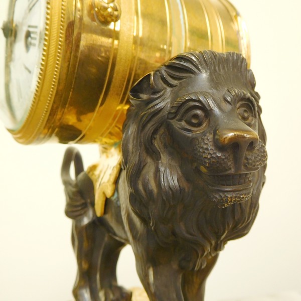 Ormolu and patinated bronze clock picturing a lion, Louis XVI style, 19th century