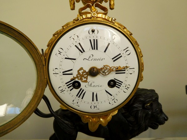 Ormolu and patinated bronze clock picturing a lion, Louis XVI style, 19th century