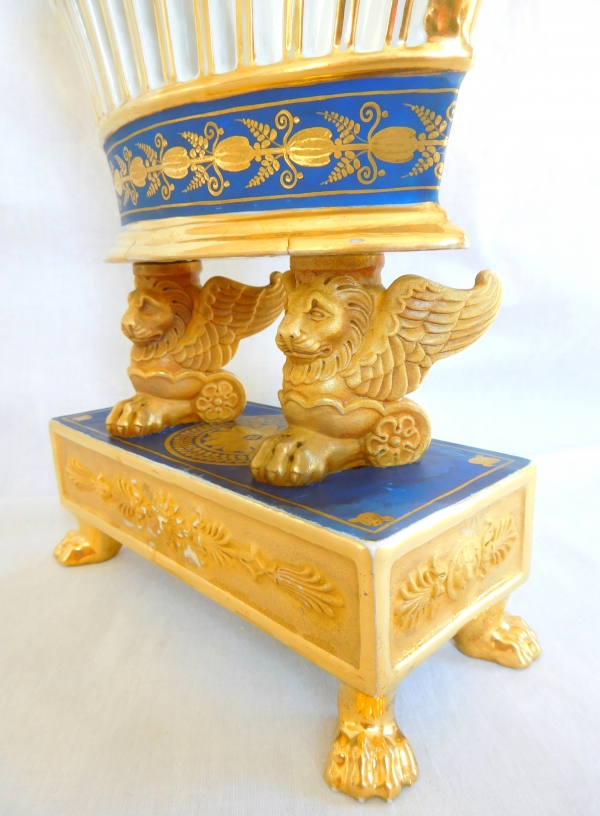 Empire Paris porcelain gilt reticulated cup held by two winged lions, early 19th century