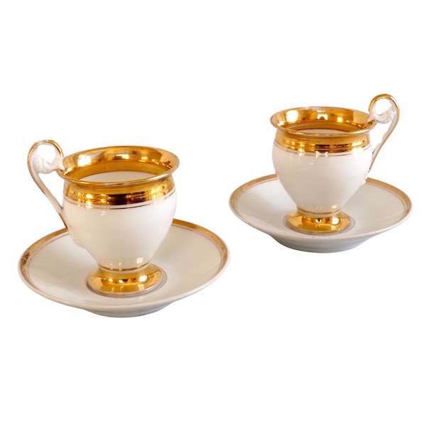 Pair of Empire Paris porcelain coffee cups enhanced with fine gold, early 19th century