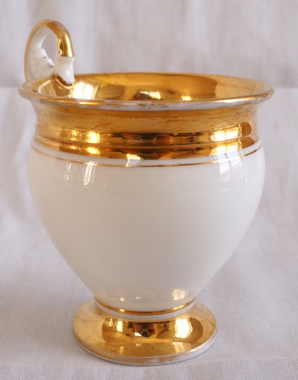 Pair of Empire Paris porcelain coffee cups enhanced with fine gold, early 19th century