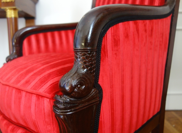 Empire mahogany bergere, dolphin-shaped armrests, early 19th century