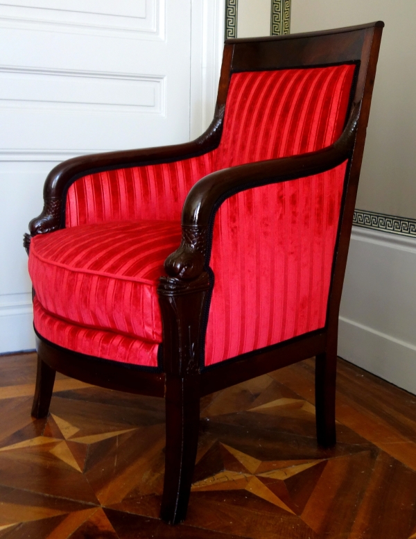 Empire mahogany bergere, dolphin-shaped armrests, early 19th century