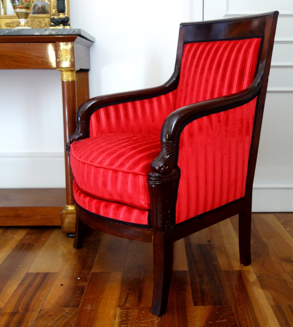 Empire mahogany bergere, dolphin-shaped armrests, early 19th century