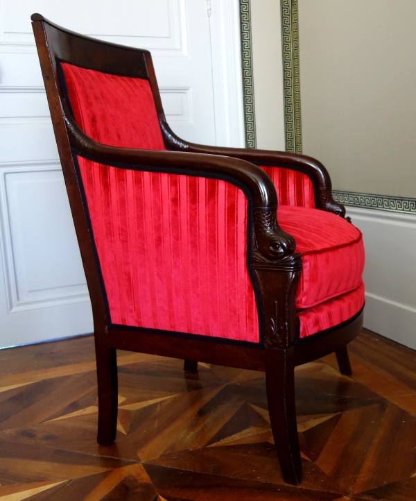Empire mahogany bergere, dolphin-shaped armrests, early 19th century